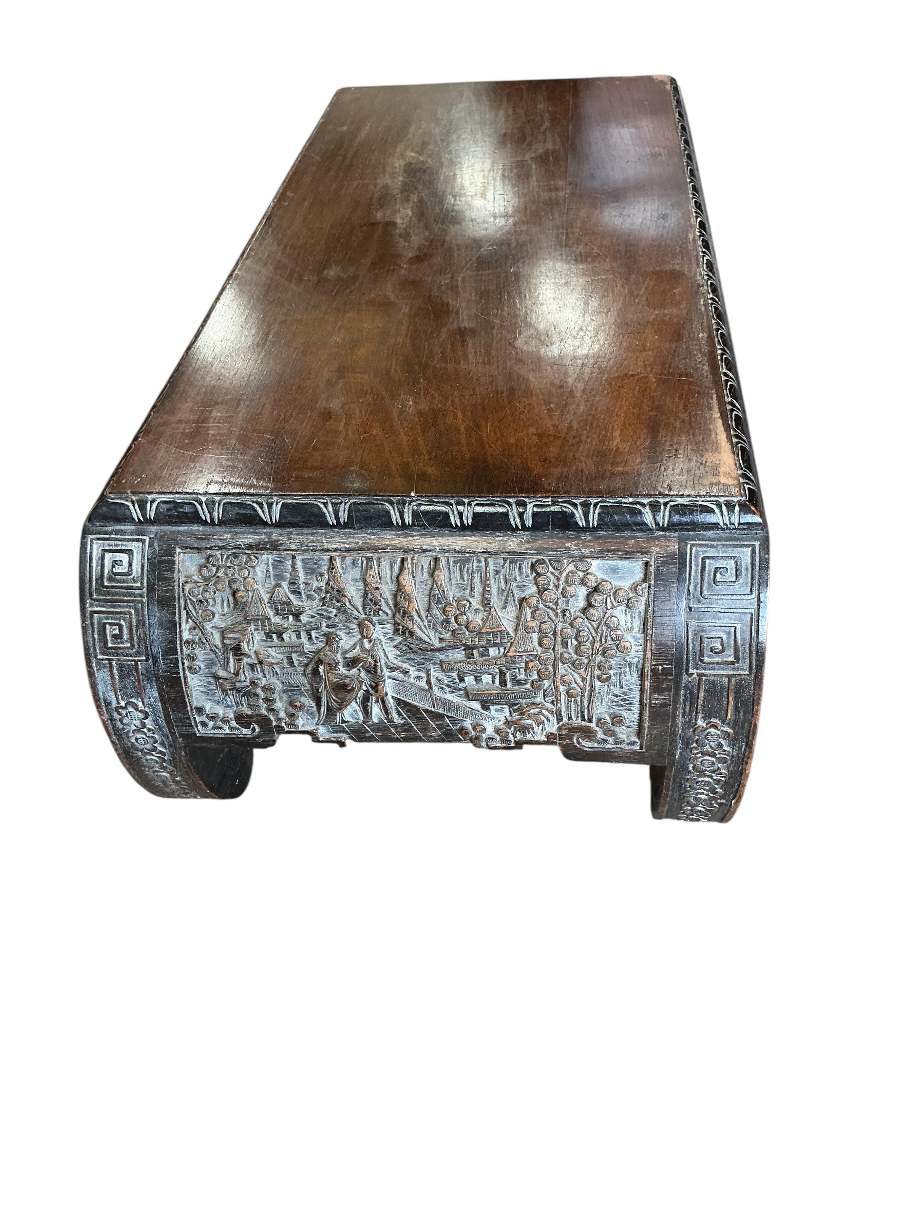 A Chinese carved low table, width 92cm, depth 40cm, height 28cm